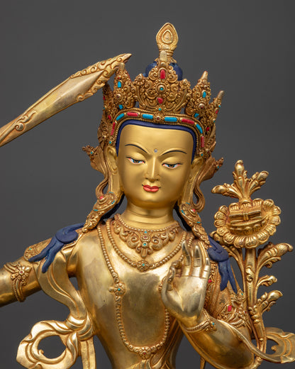 Close up of Manjushri holding utpala flower and double-edged sword for wisdom
