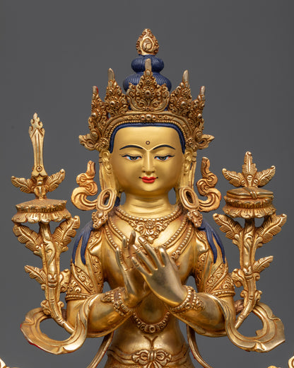 Close up of Manjushri's gold-gilded face and intricate patterned robes