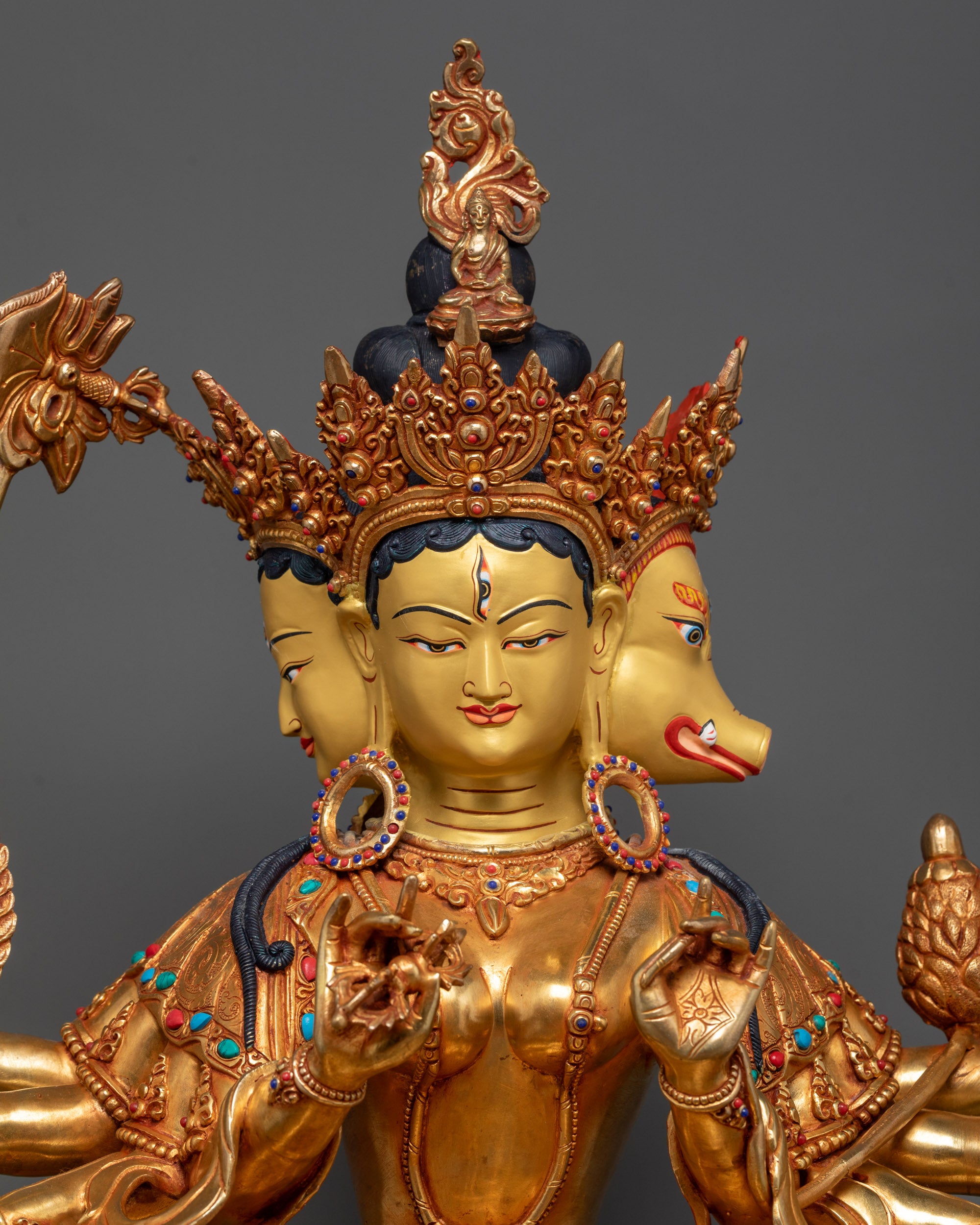 Close up of Marichi Statue showing eight arms holding sacred objects in detail