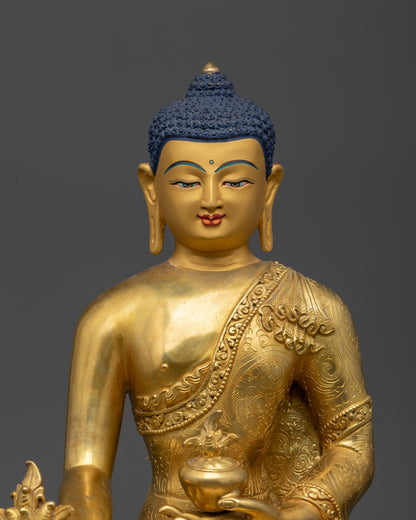 Close up of Medicine Buddha Statue showing intricate robe carvings and peaceful face
