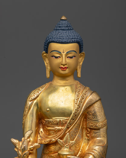 Close up of Medicine Buddha statue showing intricate robe patterns and semi-precious stones
