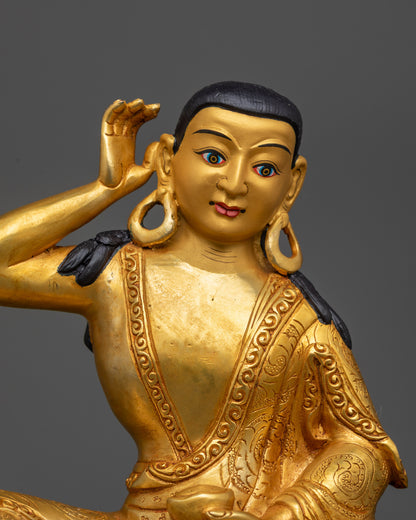 Close up of Milarepa Statue showing 24K gold-gilded face and detailed begging bowl