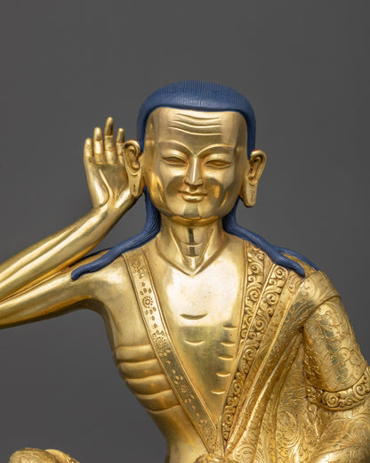 Close up of Milarepa holding begging bowl dōpa with delicately carved floral robe
