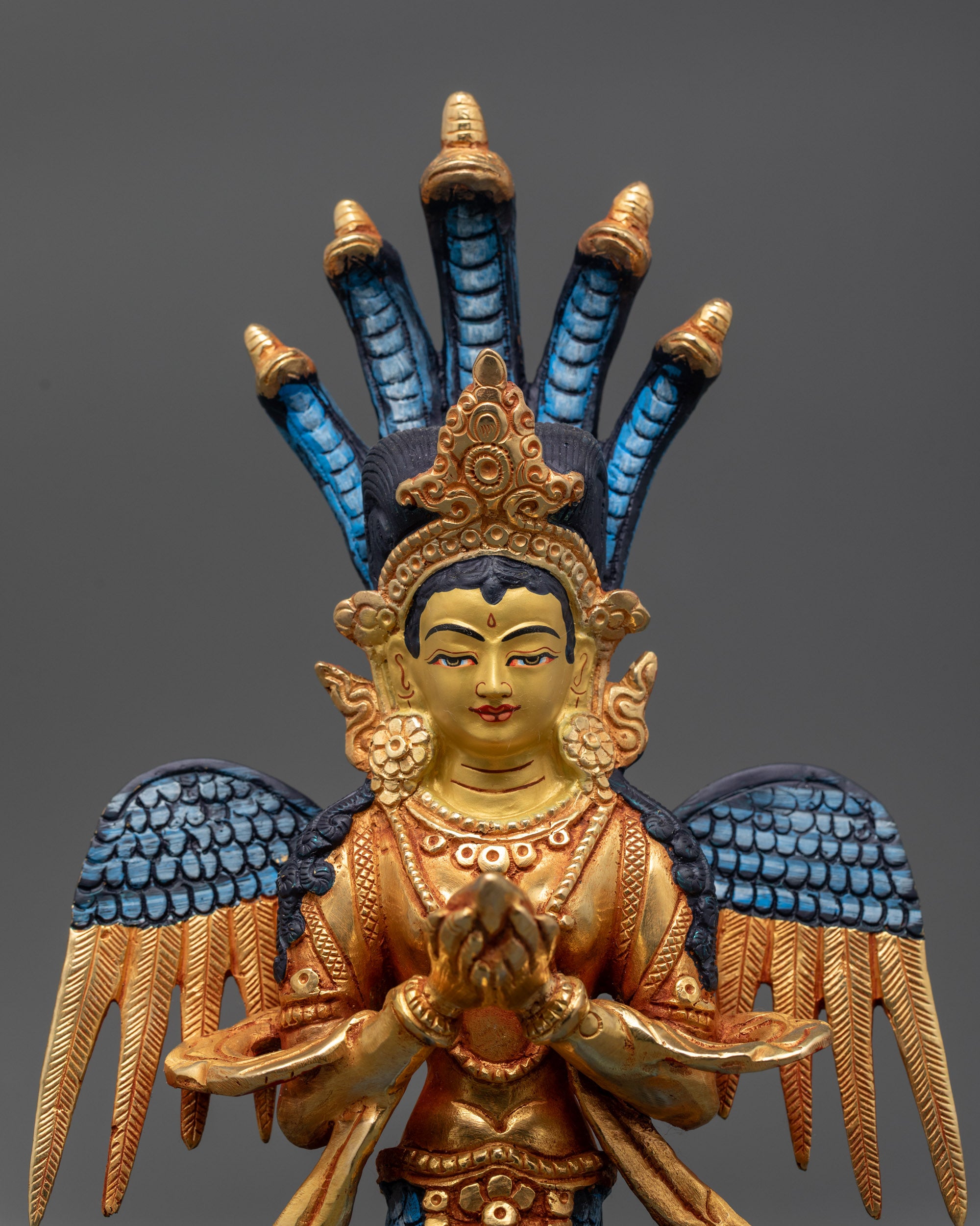 Close up of Naga Kanya half-human face with five serpents and conch shell
