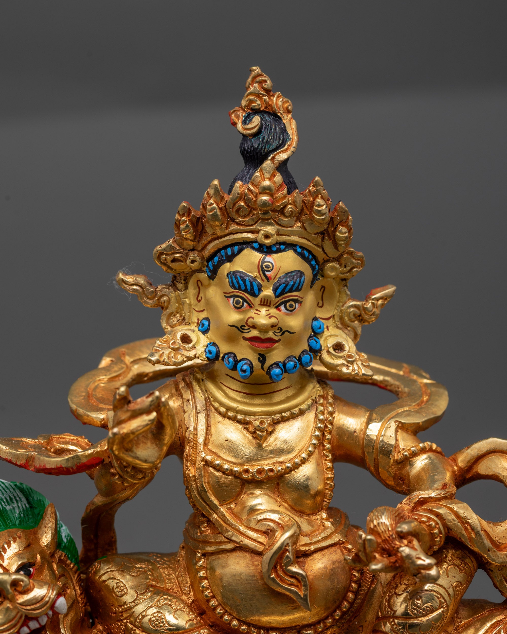 Close up of Namtoshe statue showing intricate robe details and radiant halo carvings