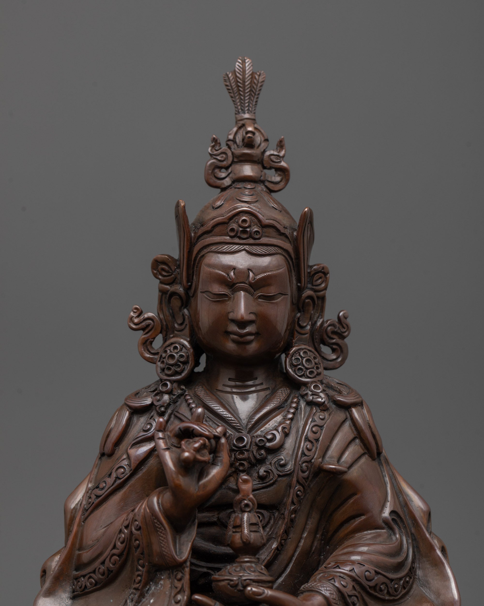 Close up of Oxidized Tsokye Dorje Statue’s oxidized copper face and intricate khatvanga trident