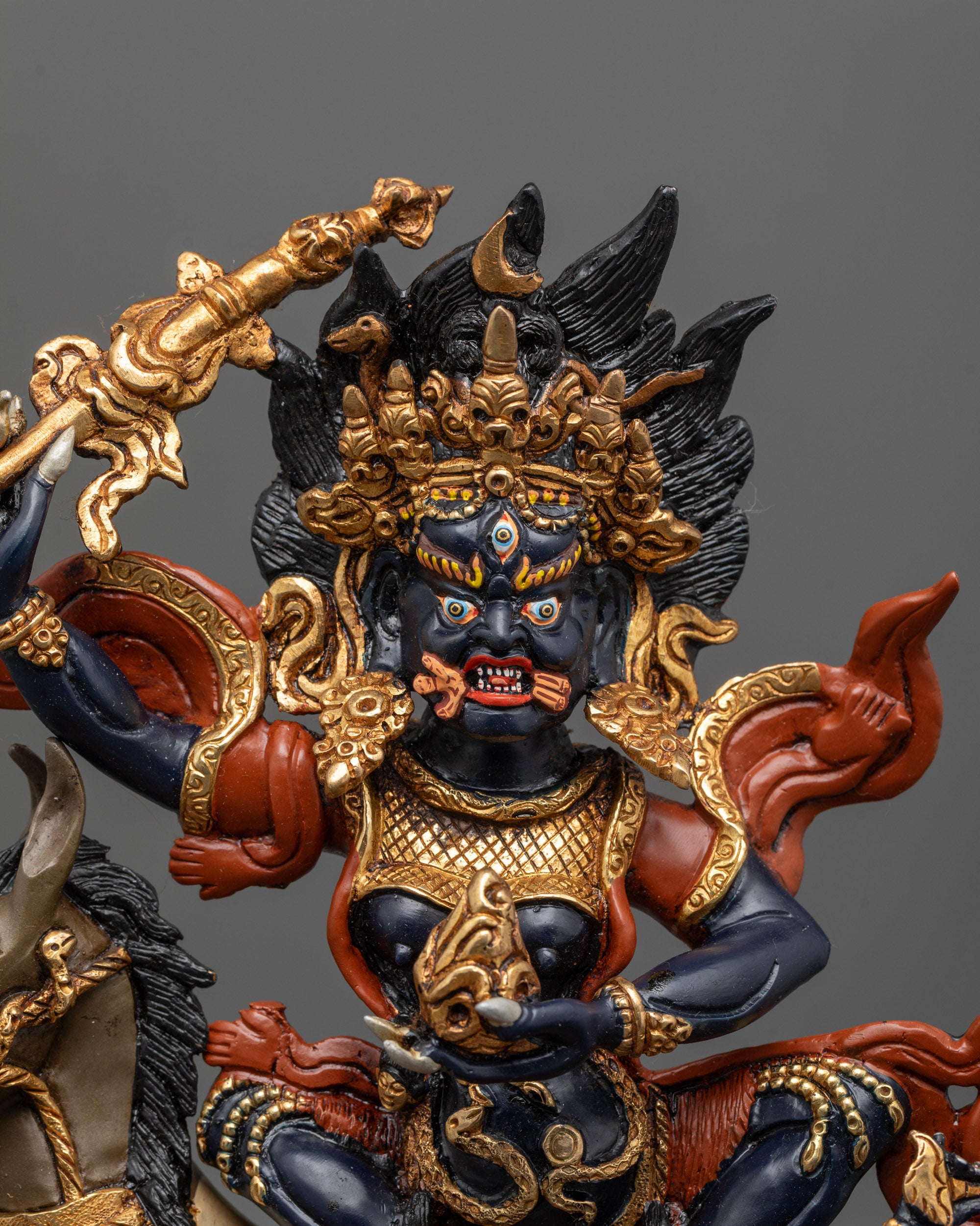 Close up of Palden Lhamo Statue with skullcup, staff and ornate crowns