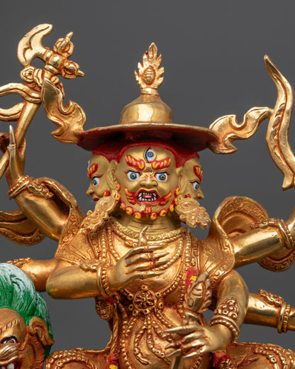 Close up of Pehar Gyalpo statue showing intricate details and six arms with weapons
