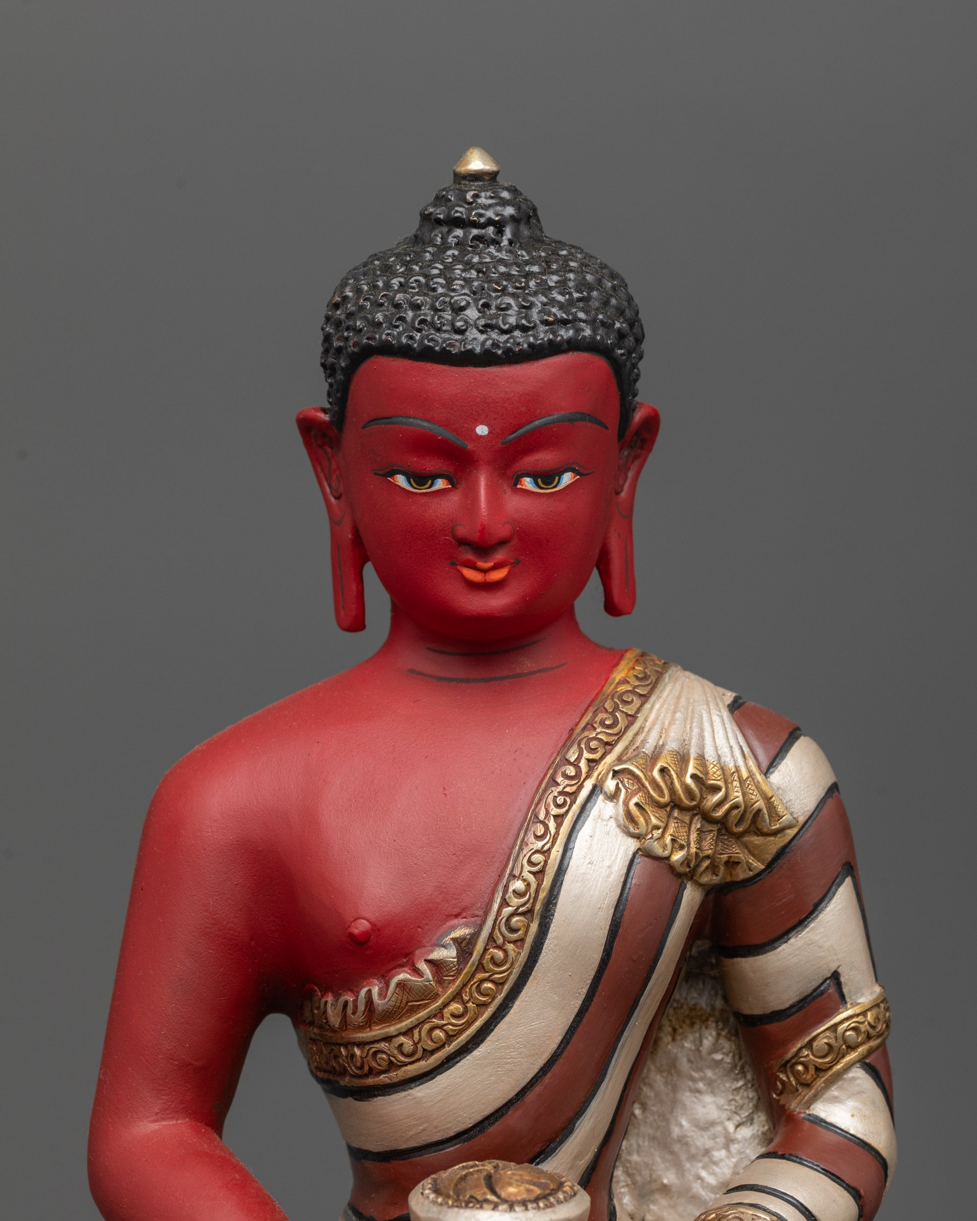 Close up of Red Amitabha Buddha Statue showing intricate carvings and gold-plated robe