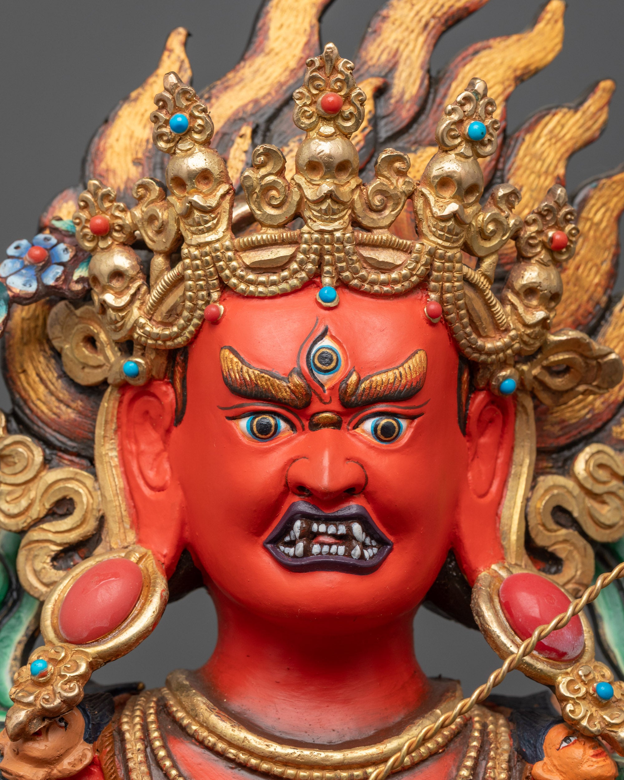 Close up of Red Kurukulla Dakini Face Sculpture showing five-skull crown and third eye details