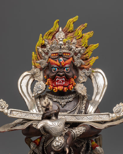Close up of Sakya Mahakala’s five-skull crown and kartika knife with silver accents