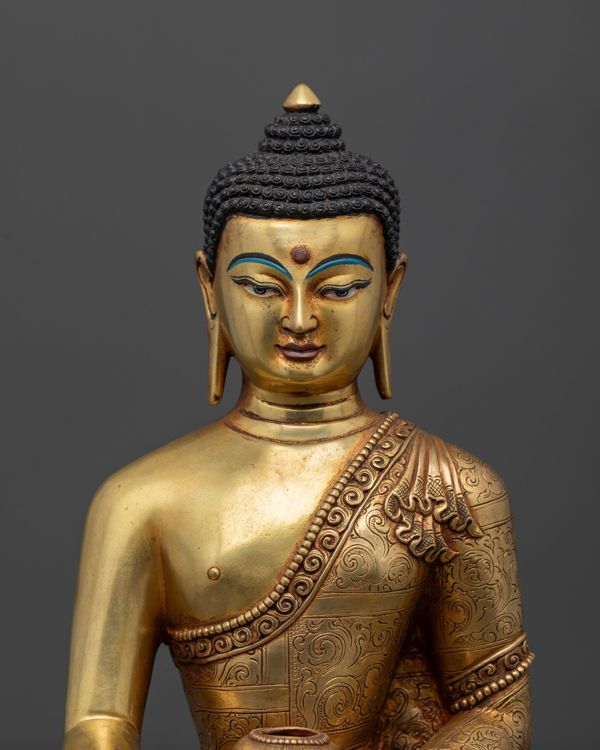 Close up of Shakyamuni Buddha Statue showing detailed Face and hand in earth-touching mudra