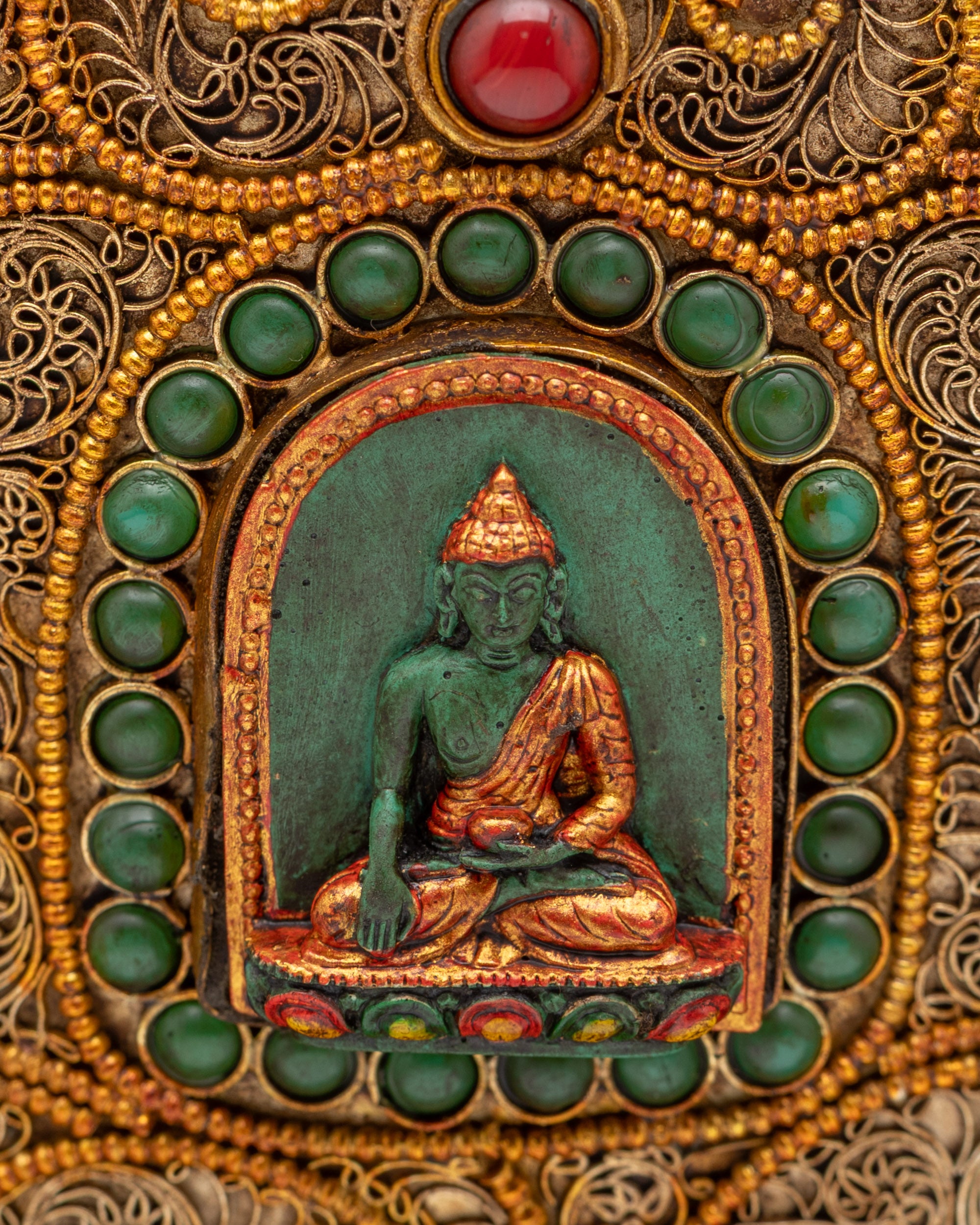 Close up of Shakyamuni Buddha carving on ritual rice pot