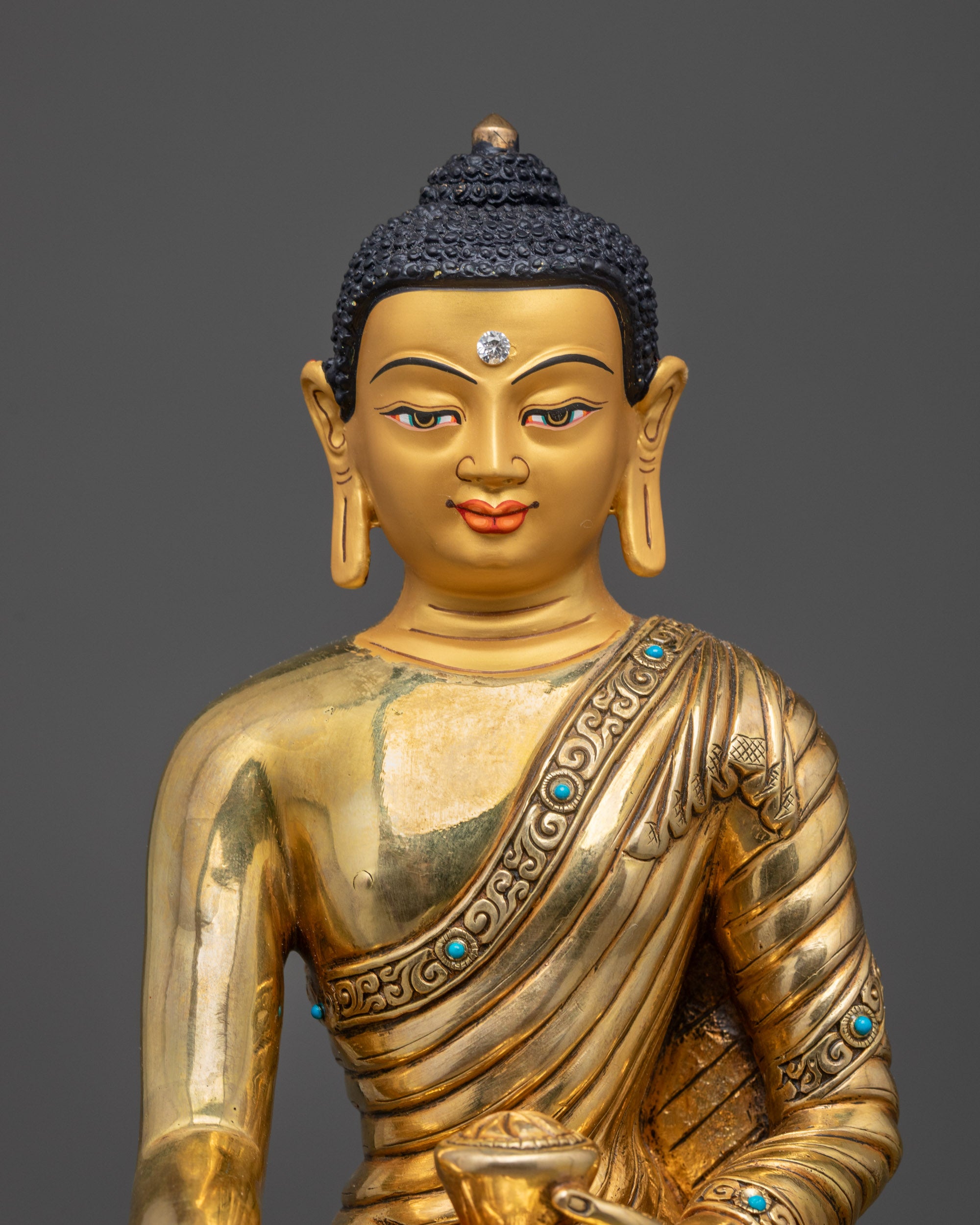 Close up of Shakyamuni Buddha statue showing bhumisparsha mudra and alms bowl details