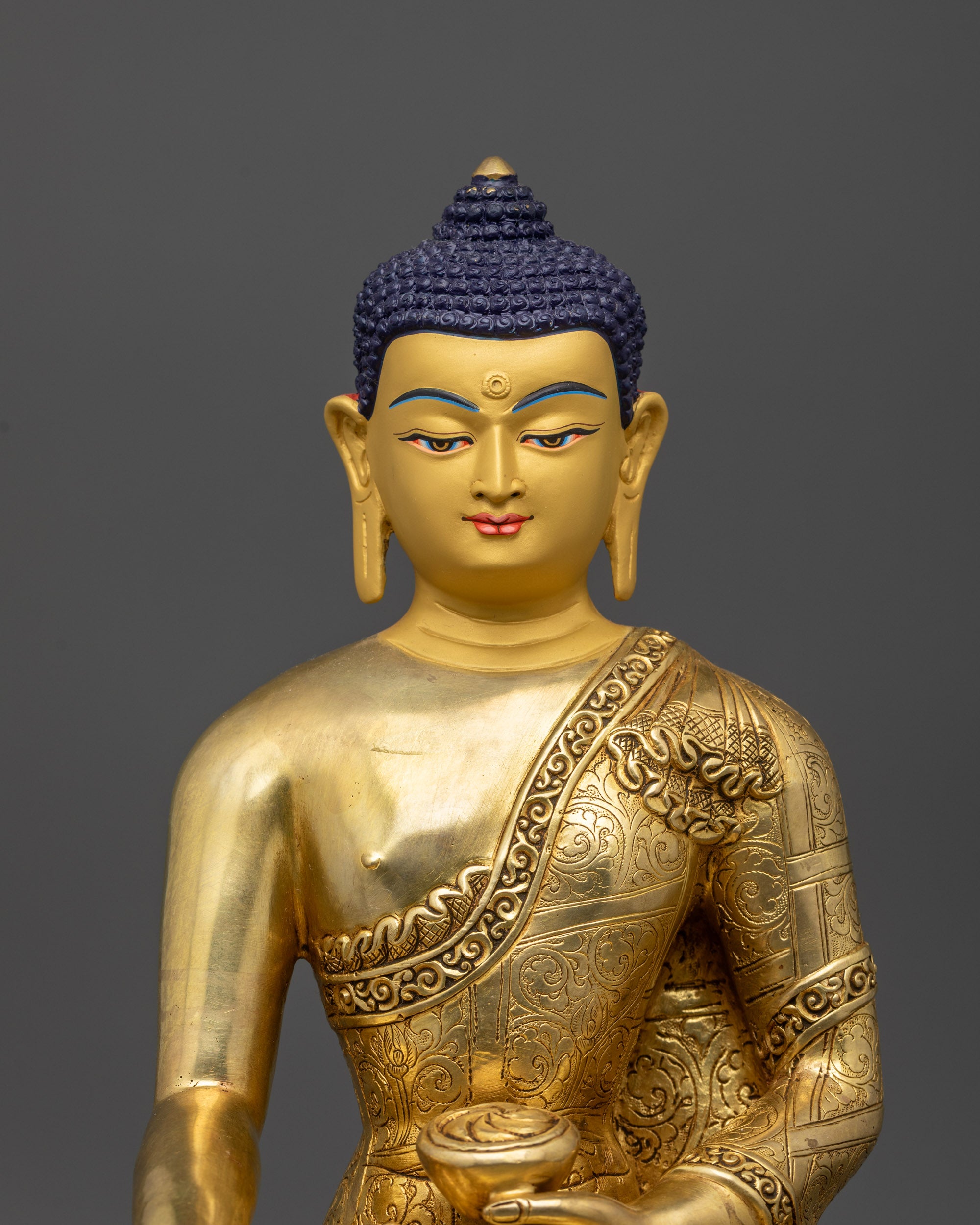 Close up of Shakyamuni Buddha statue showing intricate floral motifs and hand mudras