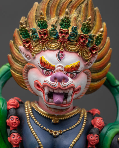Close up of Simha Mukha Statue showing fierce expression, colored face, and detailed crown