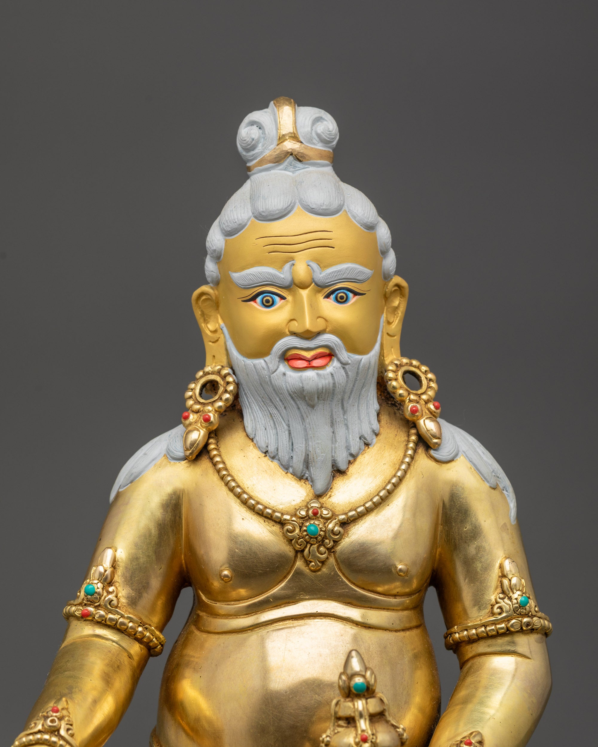 Close up of Thangtong Gyalpo gold-gilded face and detailed adornments