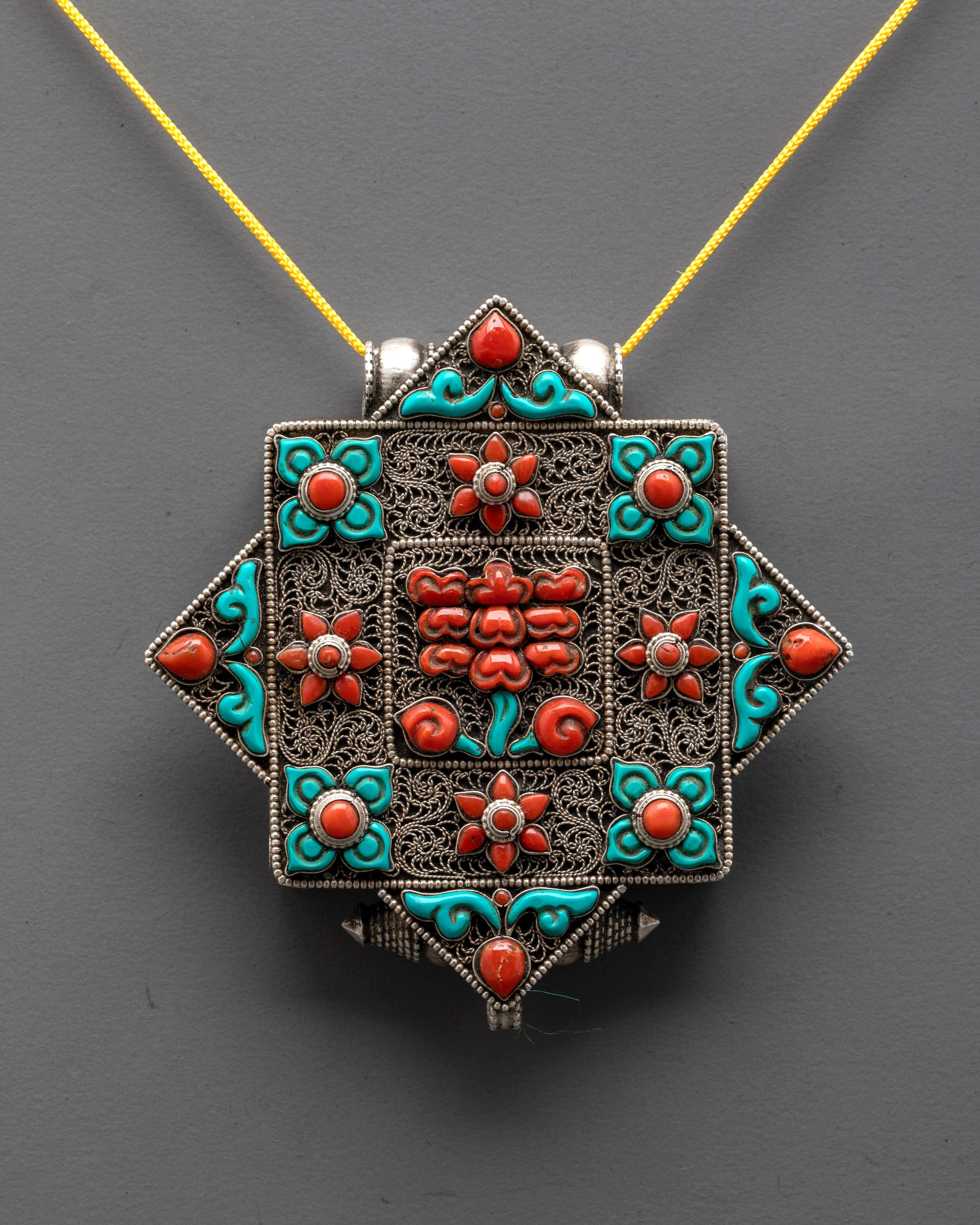 Close up of Tibetan Flower Locket showing intricate silver-plated filigree and Lotus symbol