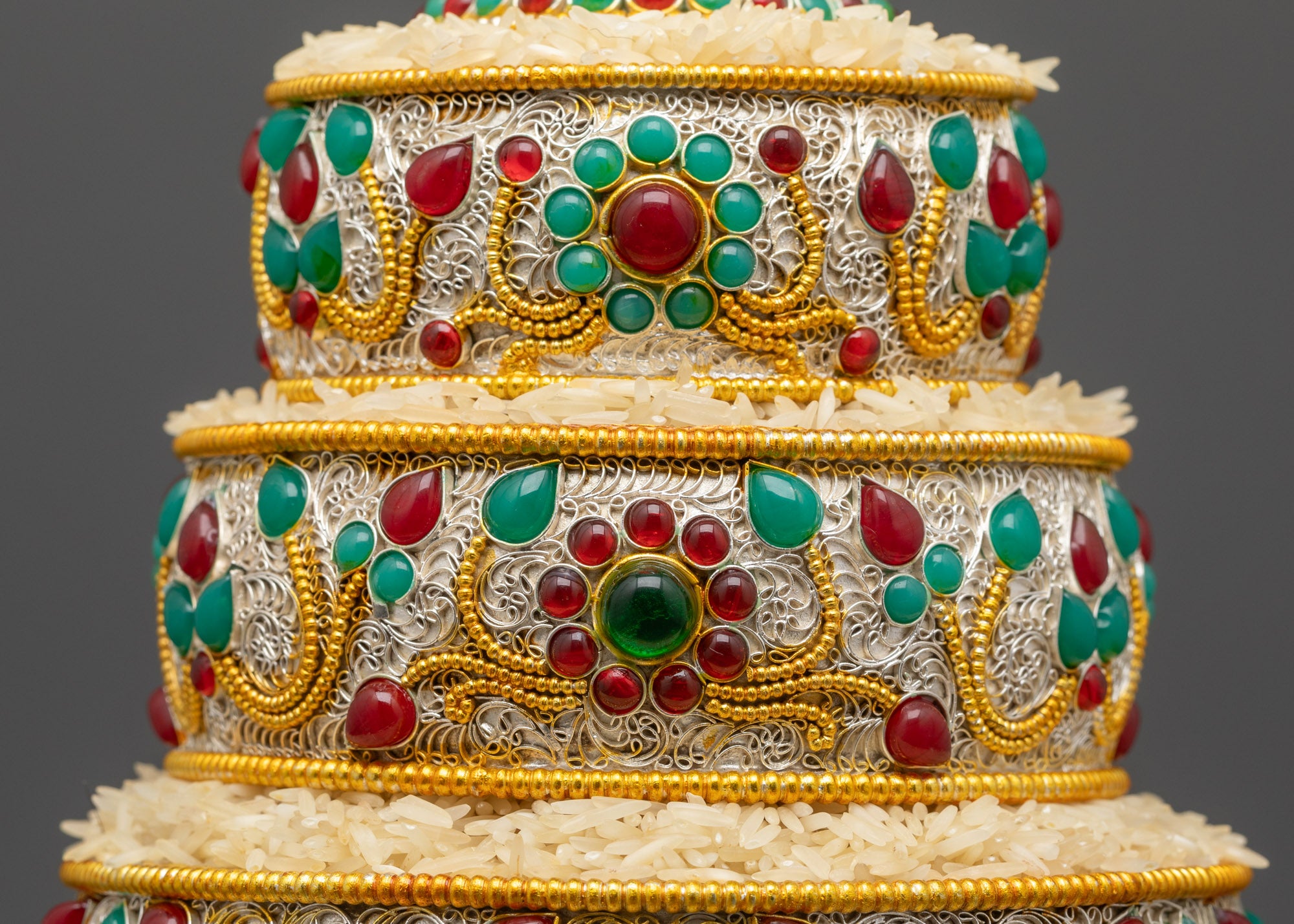 Close up of Tibetan Mandala showing intricate floral patterns and silver-gold filigree details
