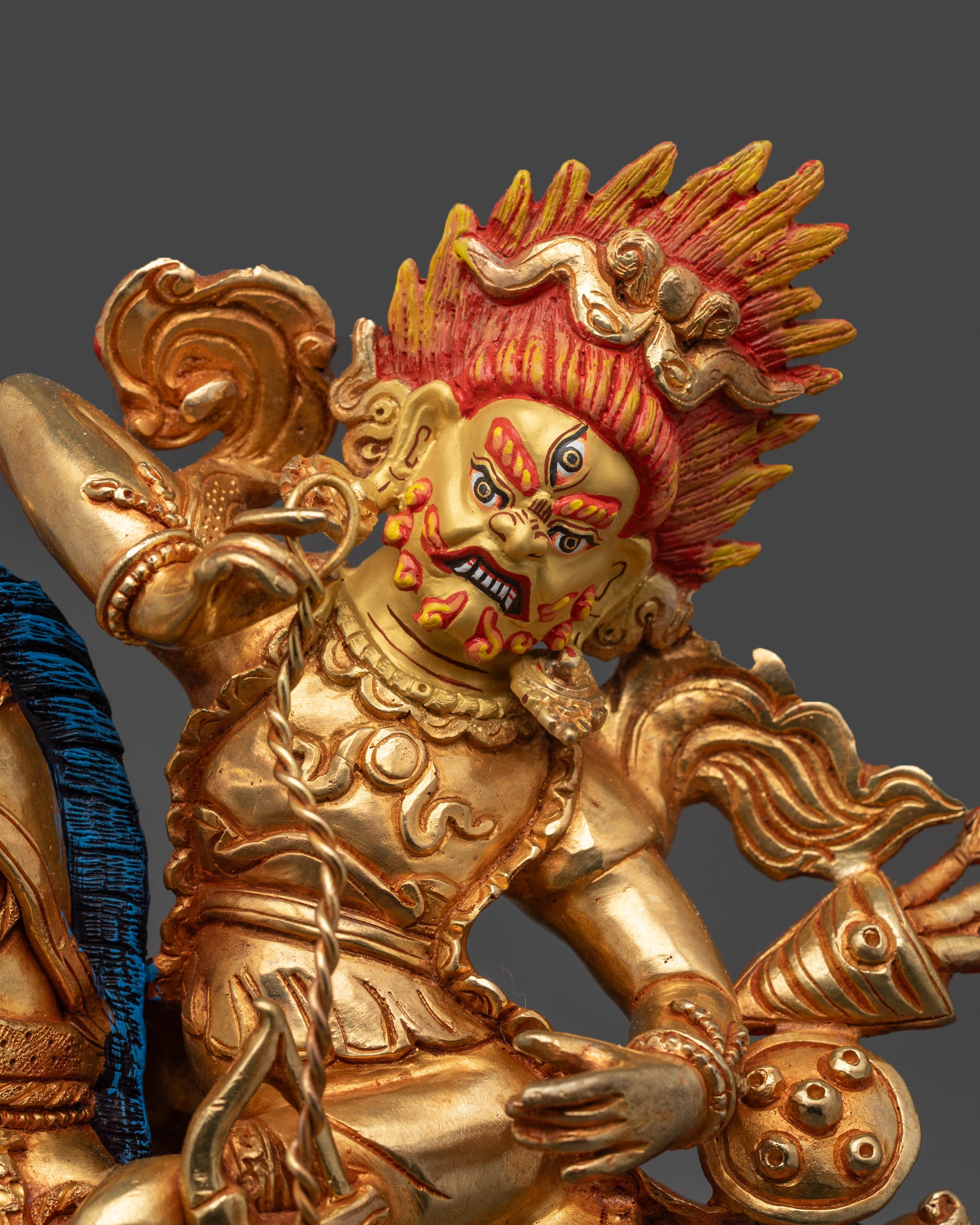 Close up of Tsengo Rolpa Chudan Statue showing intricate warrior garments and staff