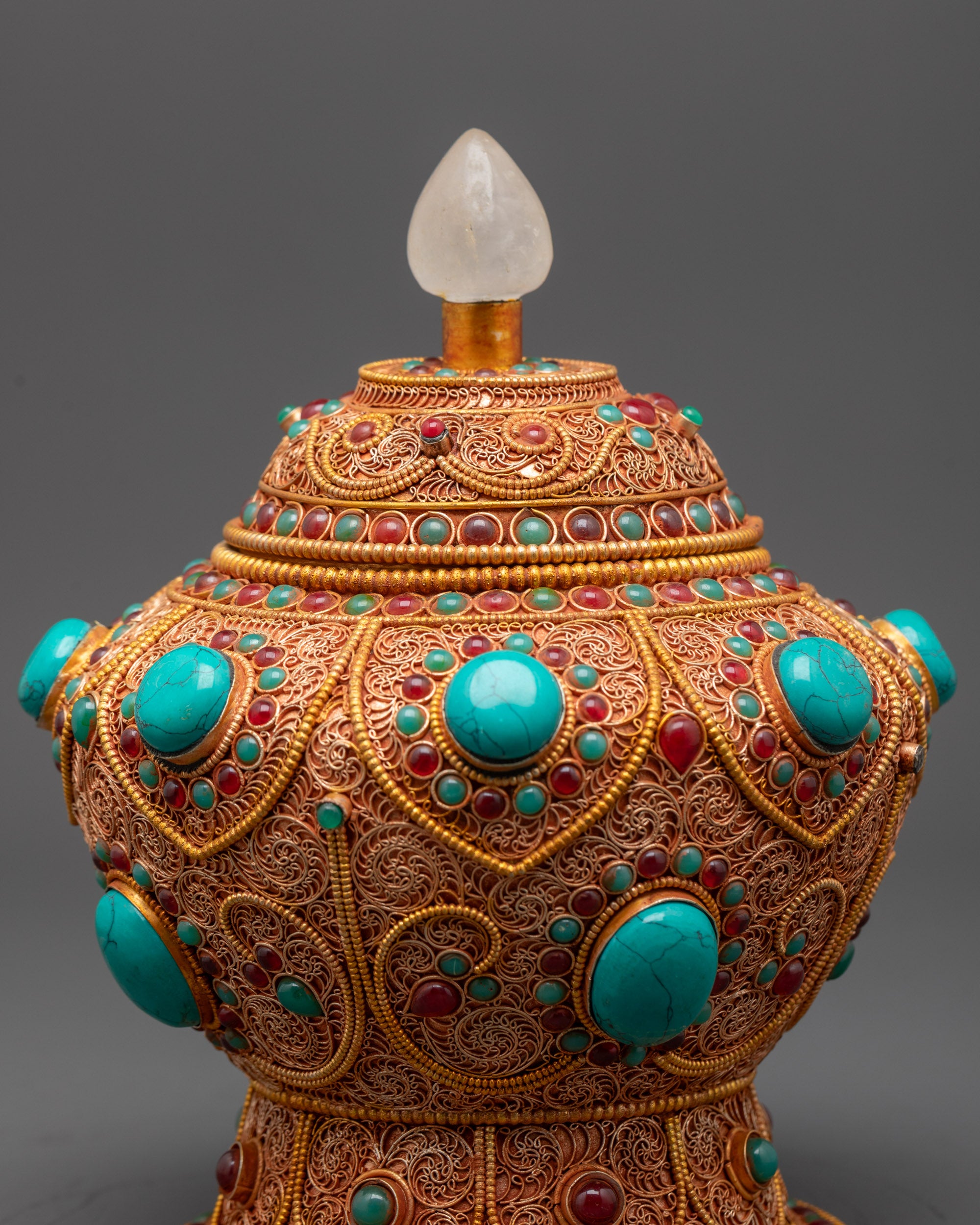 Close up of Turquoise and ruby gemstones on Neshi Rice Pot for Buddhist rituals