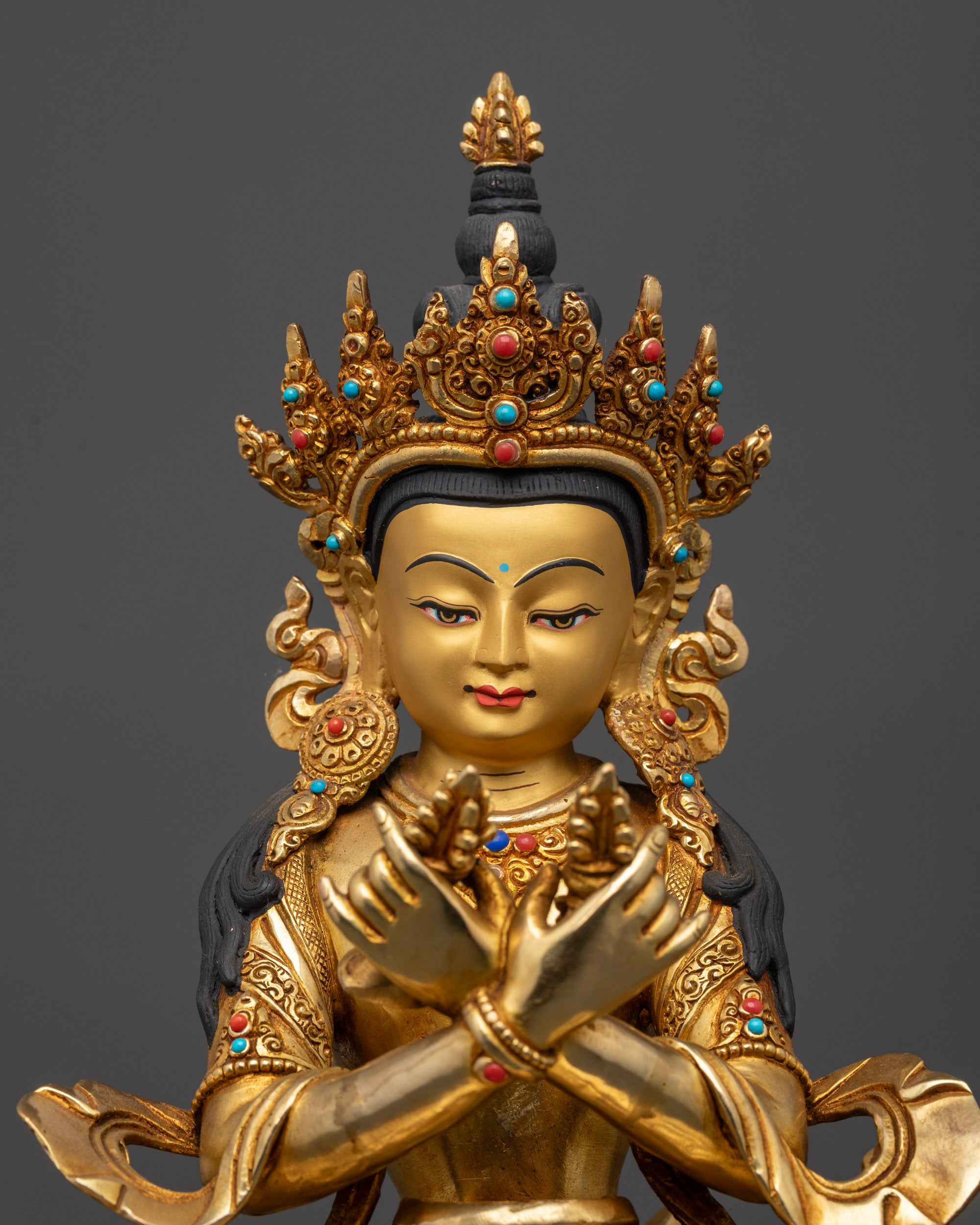 Close up of Vajradhara Yab Yum statue showing intricate crown, robe, and semi-precious stones