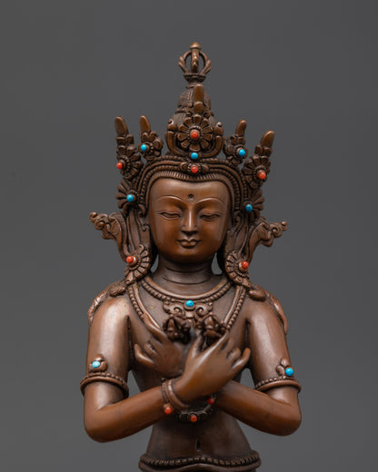 Close up of Vajradhara crown and semi-precious stone jewelry details
