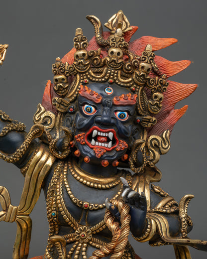 Close up of Vajrapani statue showing gold gilded details and wrathful protector expression