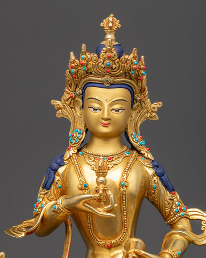 Close up of Vajrasattva Dorje Sempa face showing tranquil gaze and gold-gilded details
