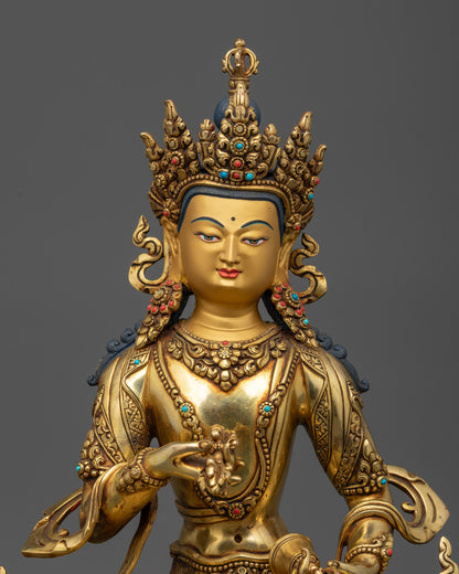 Close up of Vajrasattva Statue showing calm expression, Vajra, Ghanta, and stone-adorned robe