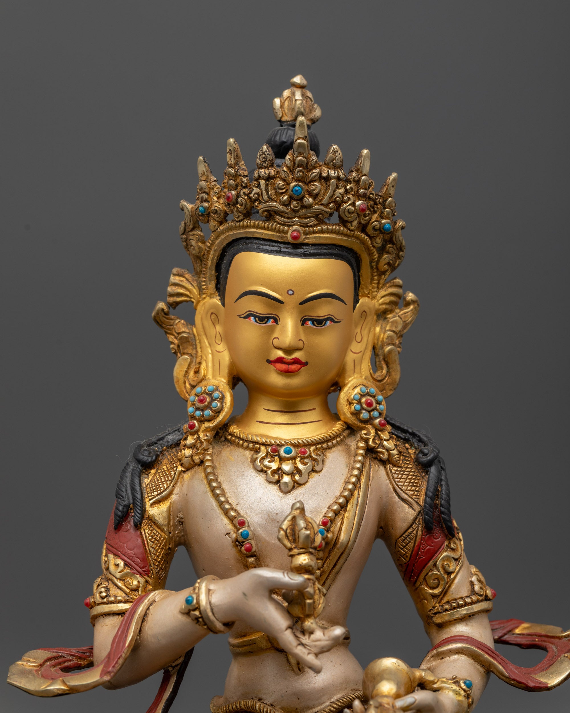 Close up of Vajrasattva Statue showing intricate carvings and gold-plated accents on robe