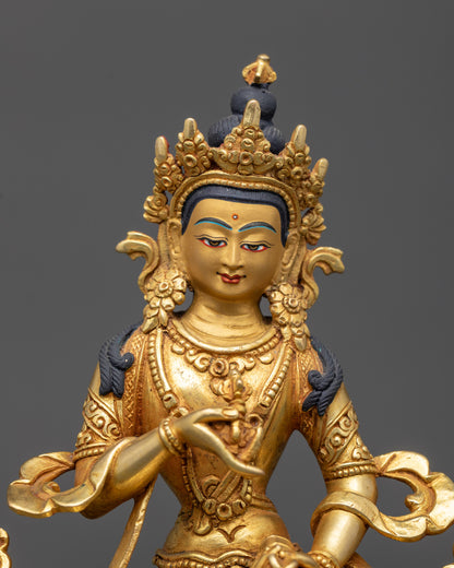 Close up of Vajrasattva holding vajra and bell, detailed gold fire-gilding and robes
