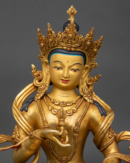 Close up of Vajrasattva holding vajra and bell, fire gilded Nepalese statue