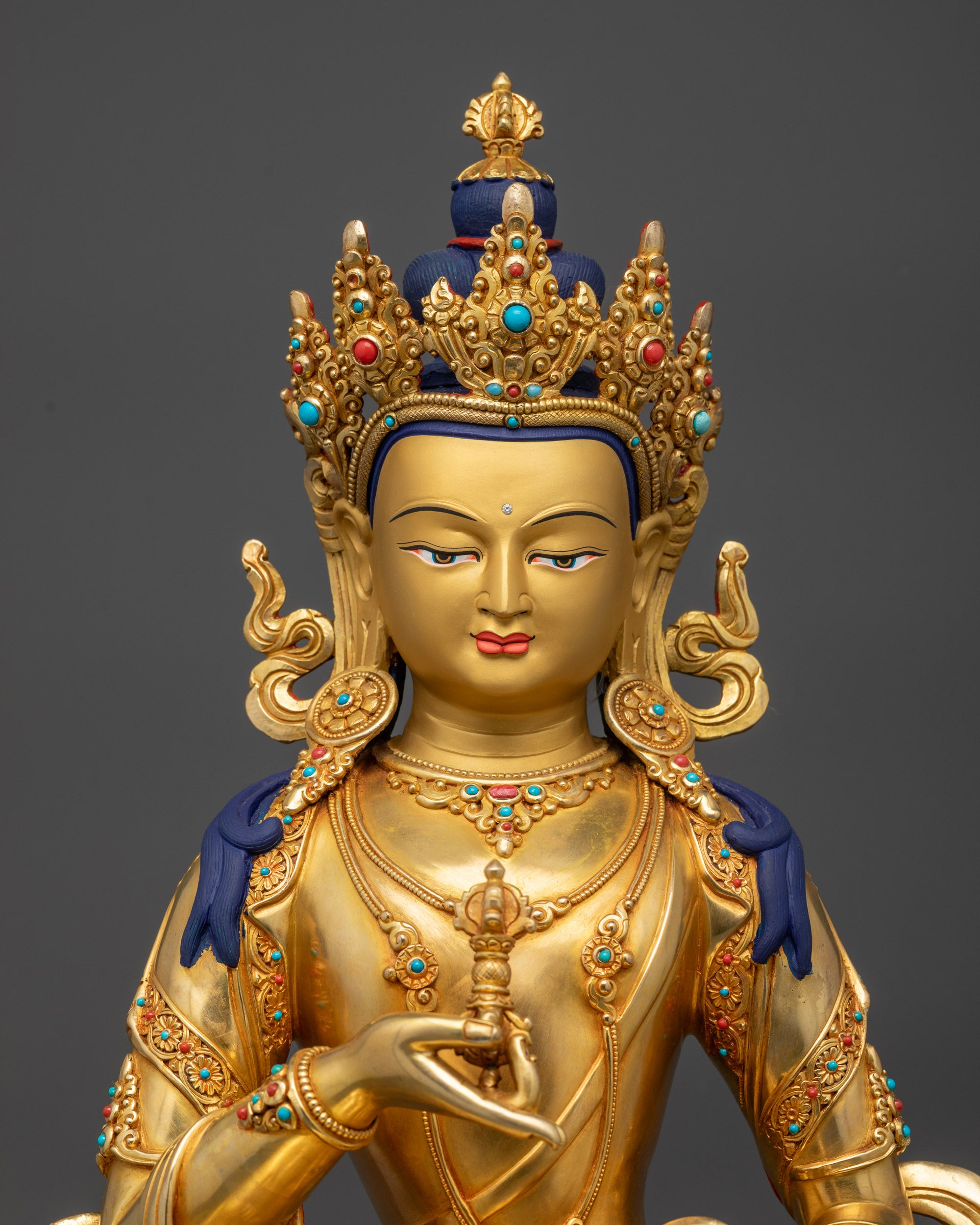 Close up of Vajrasattva robe adorned with semi-precious stones carvings
