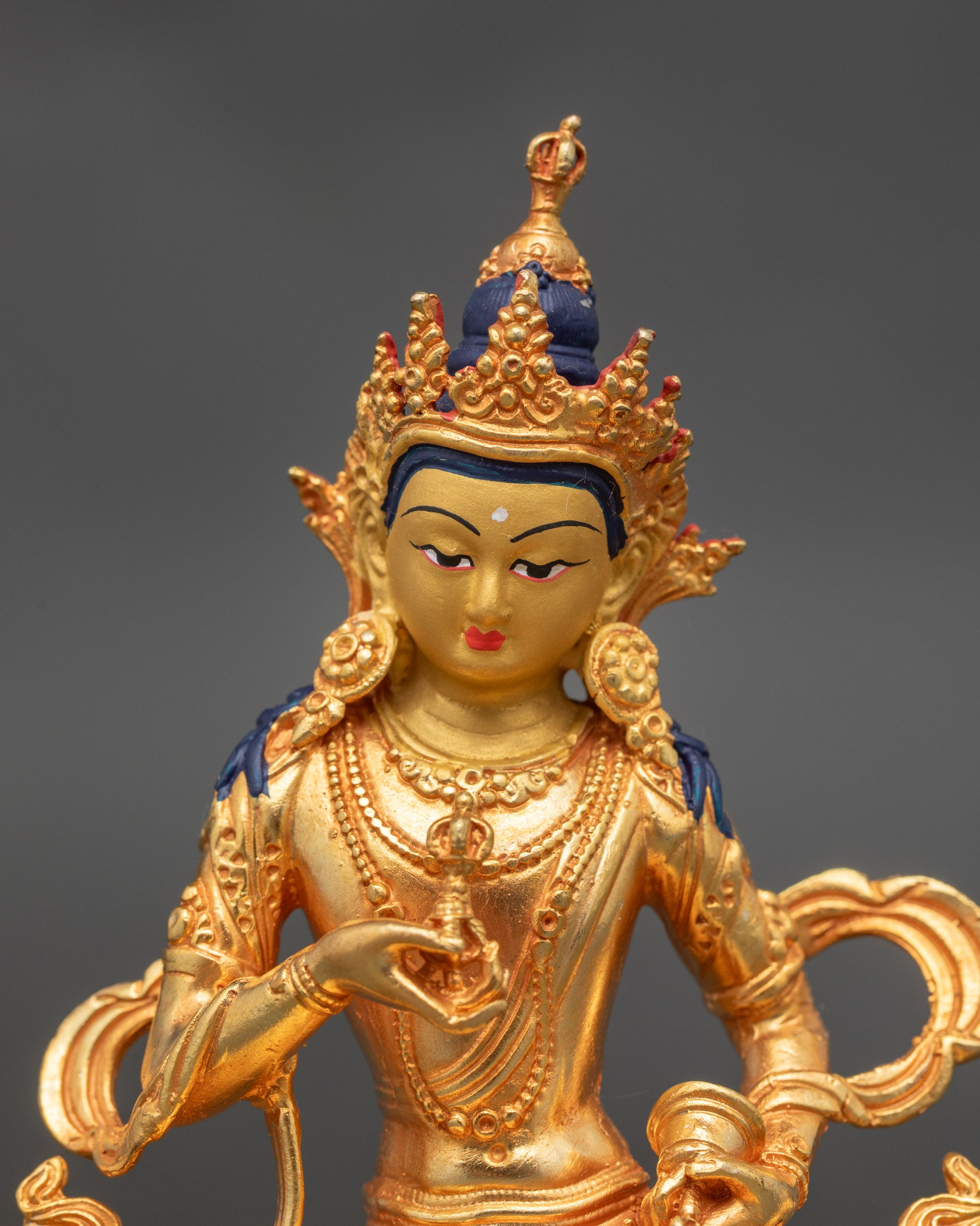 Close up of Vajrasattva statue gold face and intricate fire-gilded tantric details