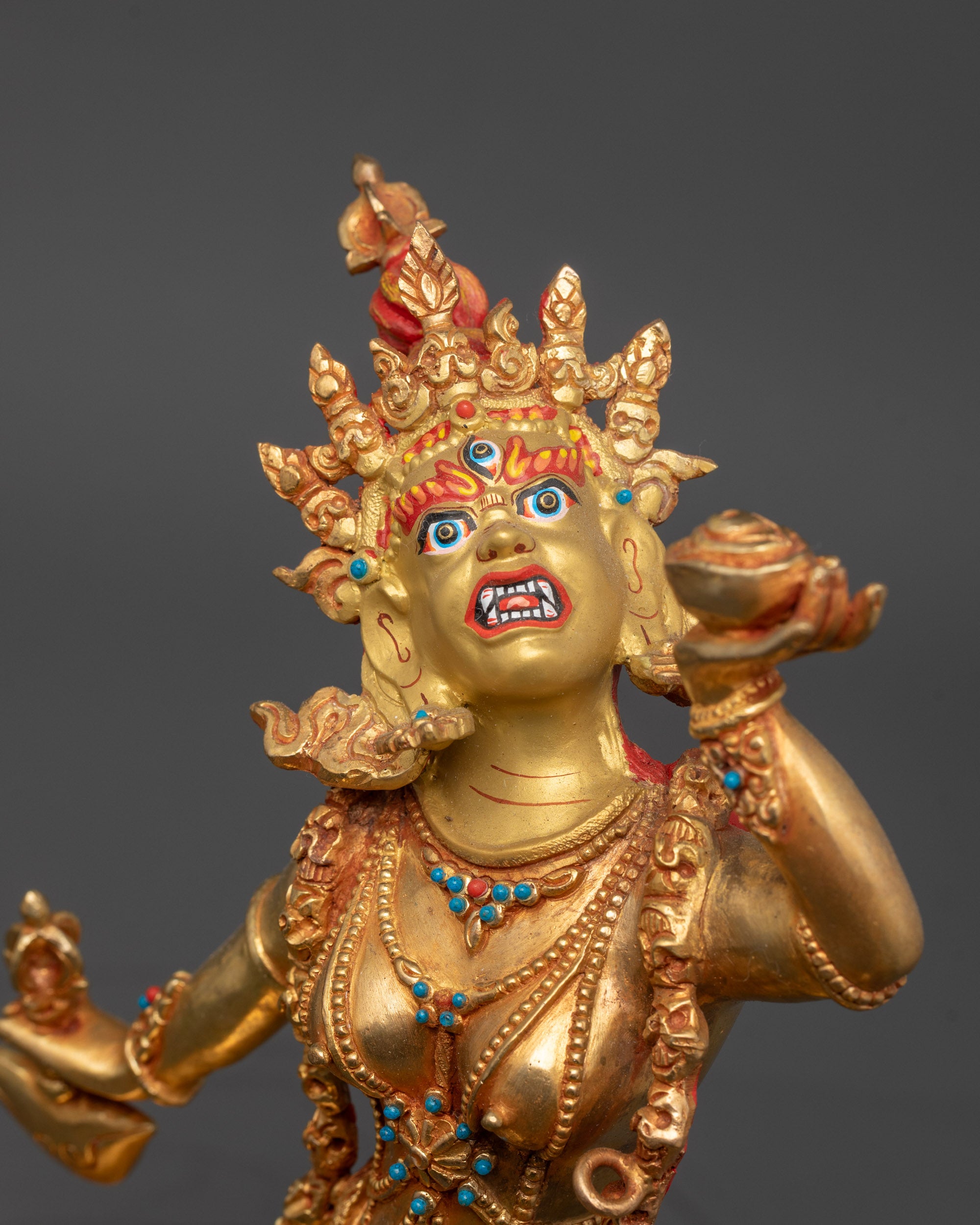 Close up of Vajrayogini Statue showing kartaika knife, skull cup, and semi-precious stones