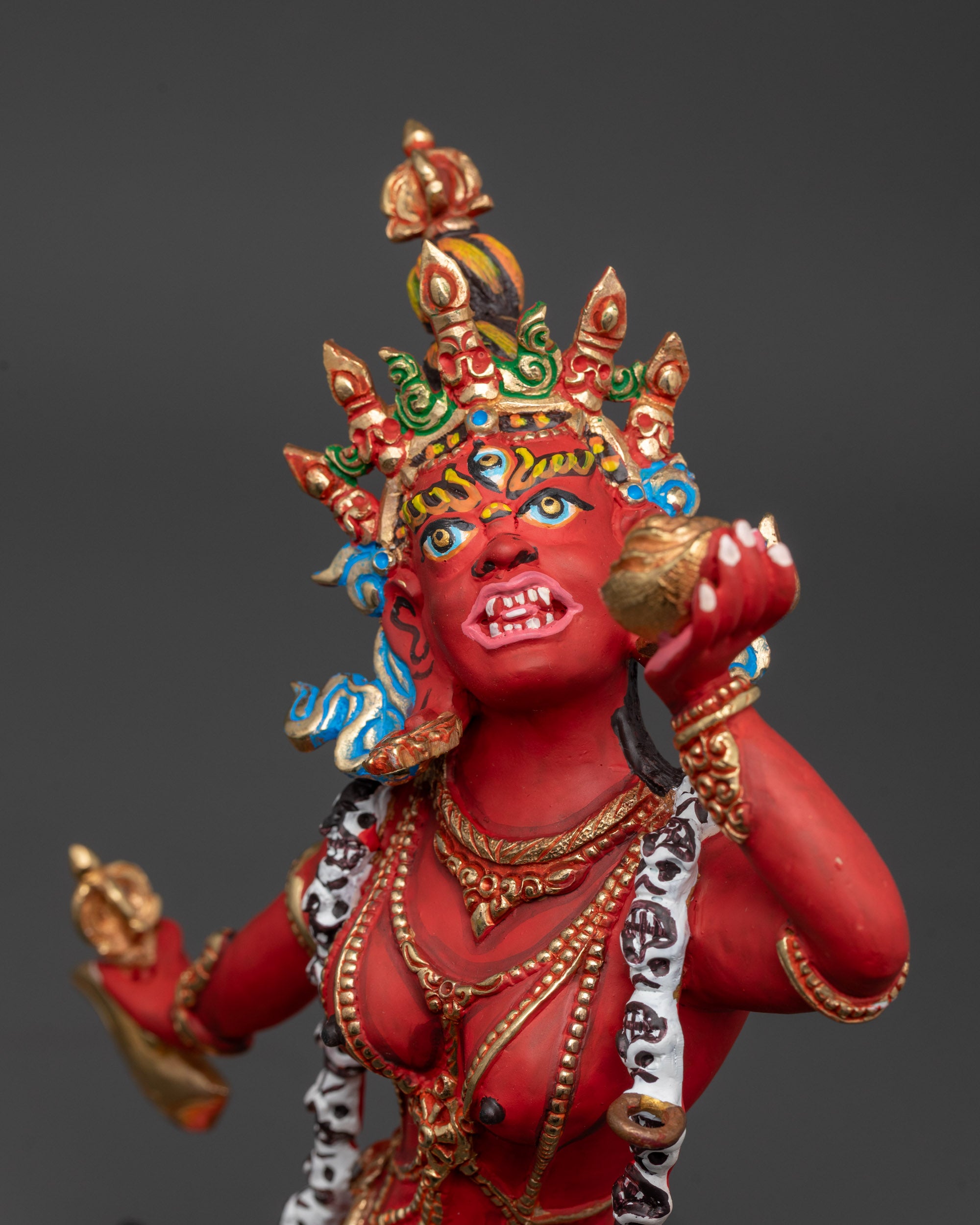 Close up of Vajrayogini statue showing kartaika knife, skull cup, and trident details