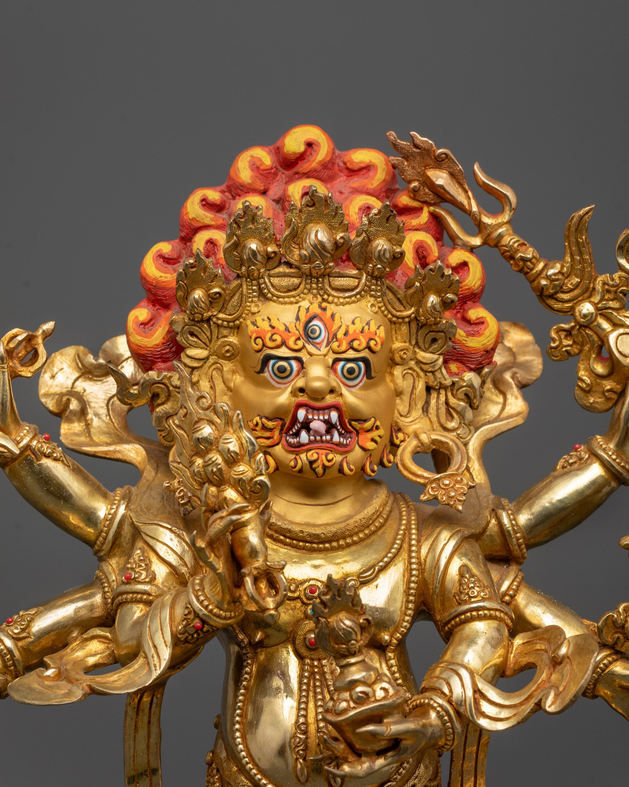 Close up of White Mahakala’s fierce face showing crown, jewelry, and intricate carvings