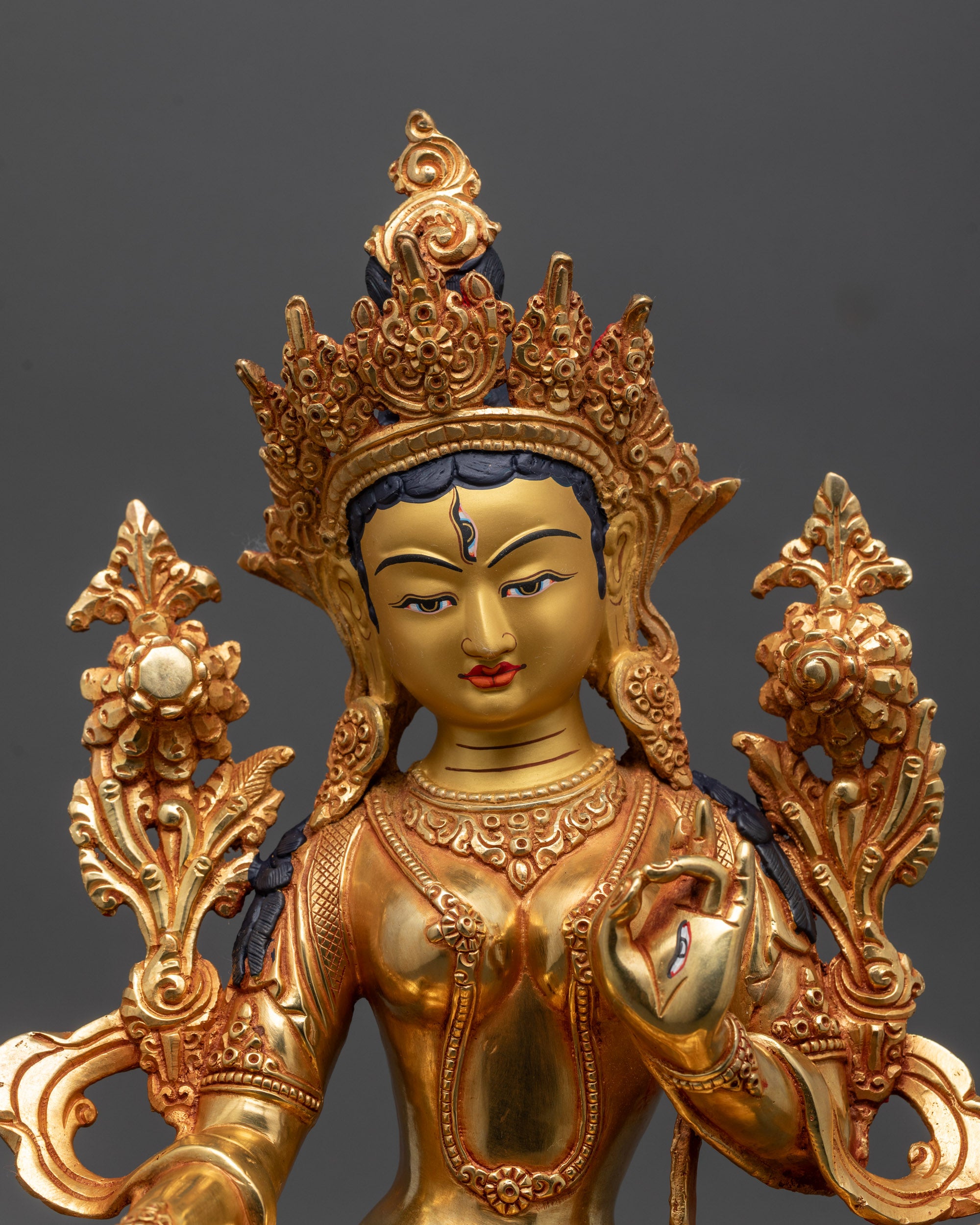 Close up of White Tara Sculpture showing seven all-seeing eyes and intricate lost-wax details
