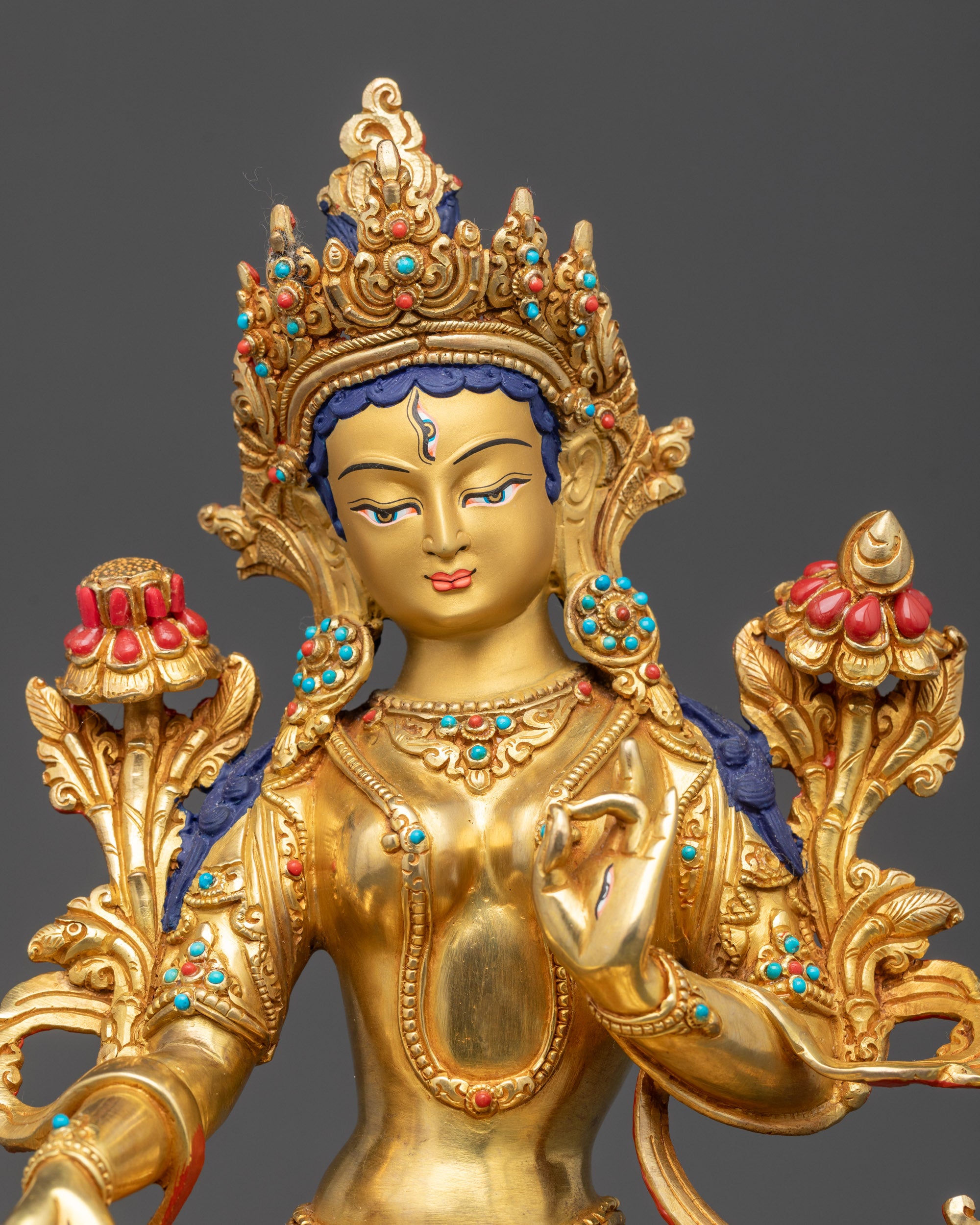 Close up of White Tara Statue face showing serene expression and seven seeing eyes
