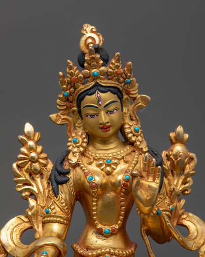 Close up of White Tara sculpture showing serene expression and seven eyes for protection
