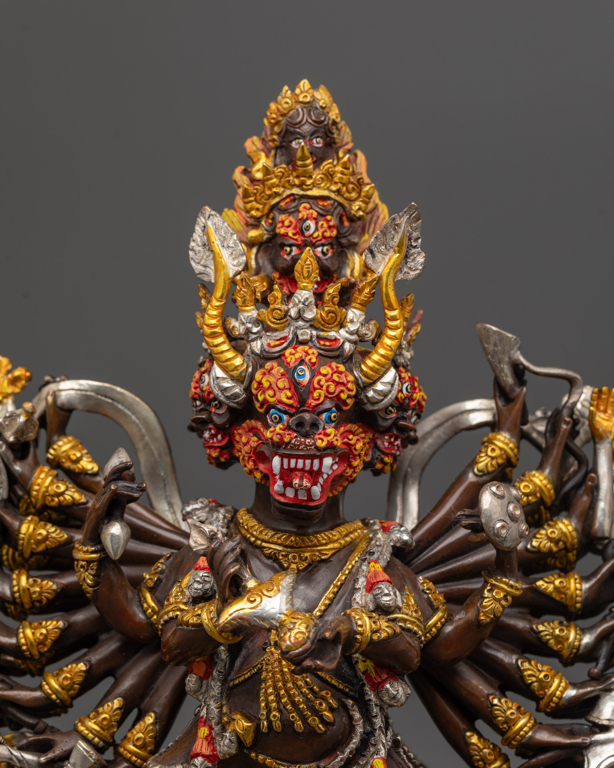 Close up of Yamantaka Statue showing gold and silver plated heads and intricate carvings