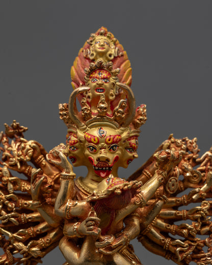 Close up of Yamantaka Yab-Yum statue highlighting nine faces and sixteen arms on copper base