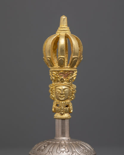 Close up of bronze bell handle with hand-carved sacred deity and symbolic patterns