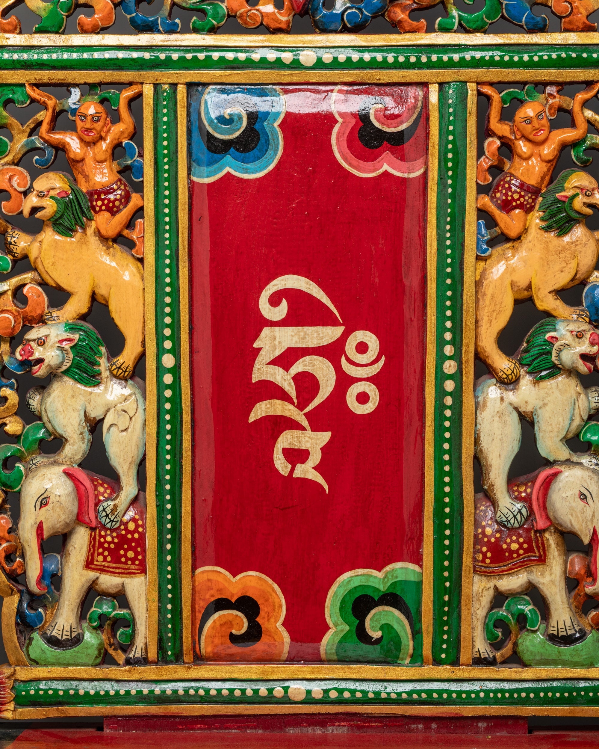 Close up of carved wood Buddhist throne showing intricate artisan craftsmanship
