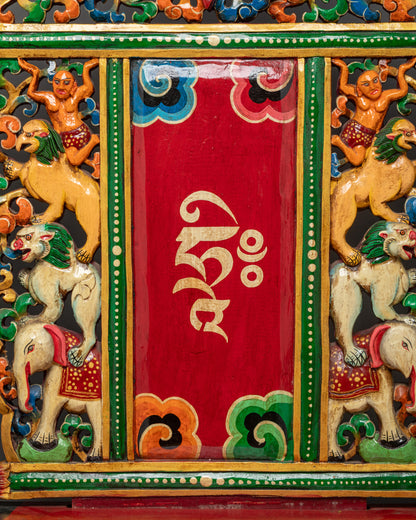 Close up of carved wood Buddhist throne showing intricate artisan craftsmanship
