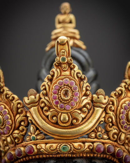 Close up of crown showing five-jewelled top with Buddha figure