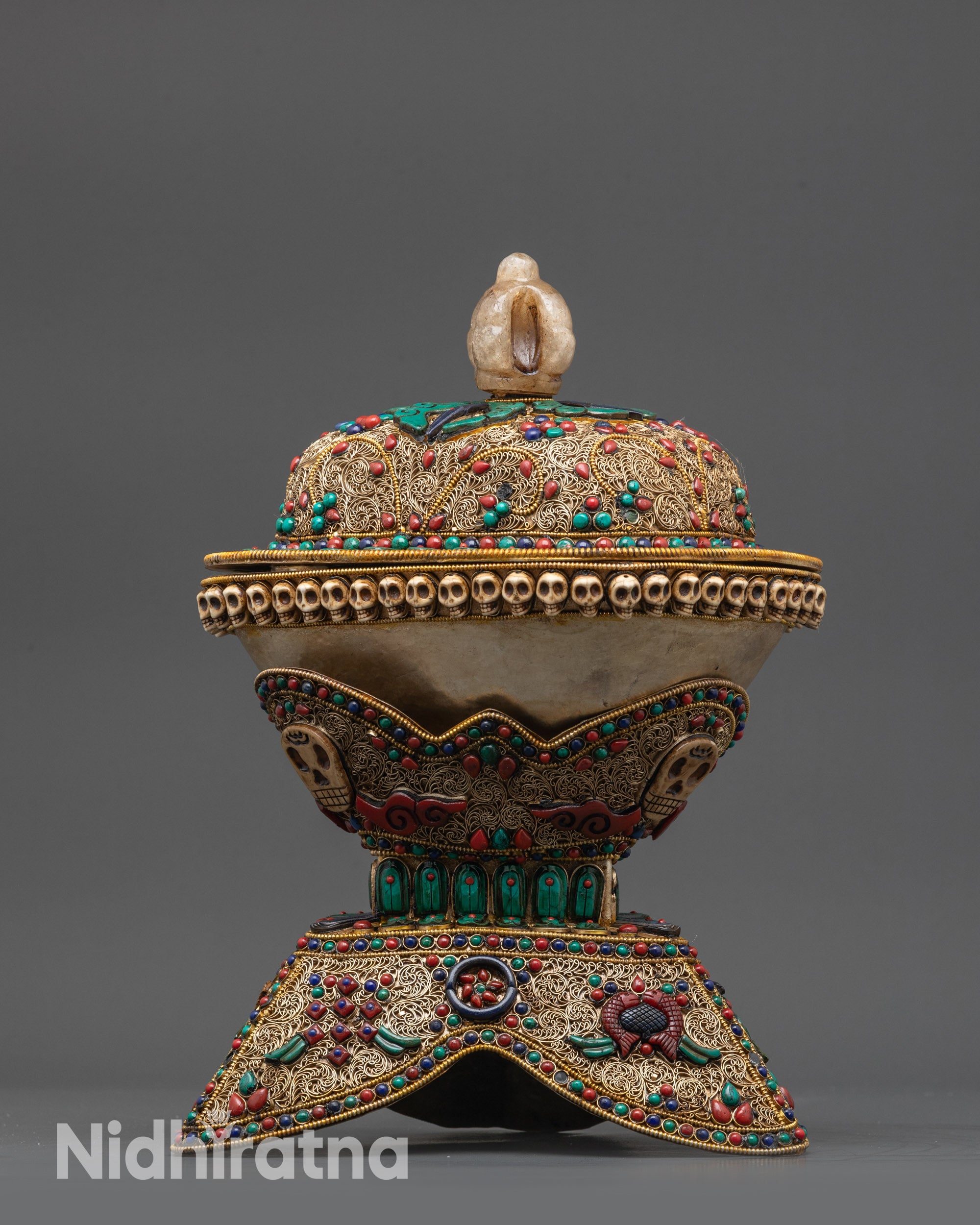 Close up of crystal-bodied Kapala with gold-plated half vajra lid and intricate stone patterns