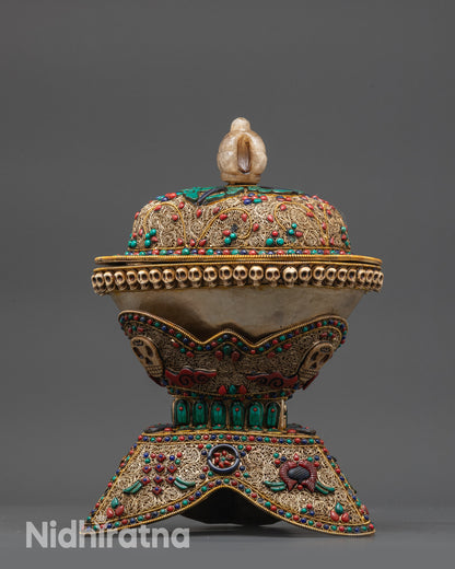 Close up of crystal-bodied Kapala with gold-plated half vajra lid and intricate stone patterns