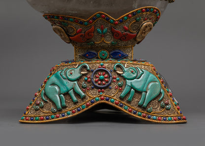 Close up of crystal skullcup and semi-precious stones forming sacred motifs
